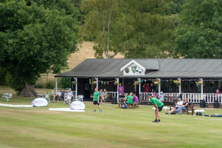 Players outside a cricket club pavilion